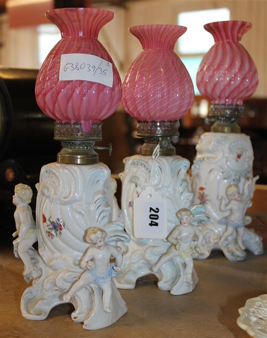 3 ceramic table lamps with child figures & pink glass shades